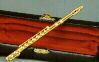 Gold Miniature Flute in case approximately 2.5"
