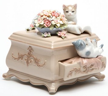 Porcelain kittens on a dresser figurine musical