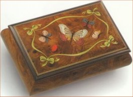 Elm Music box features a butterfly, ladybug and other friends with graceful border of ribbon and bows 