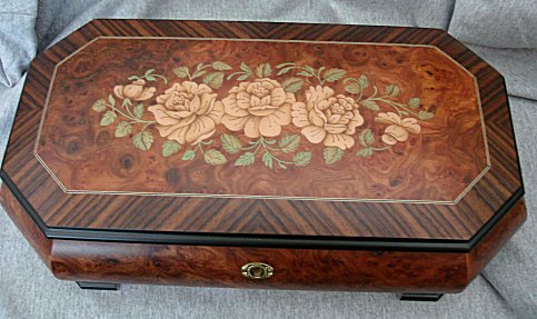 large elm and rosewood music box with inlay of three roses.