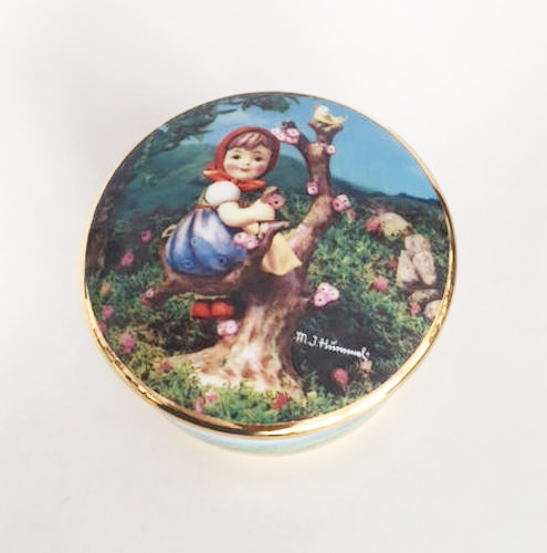 porcelain keepsake music box features Hummel's Apple Tree Girl