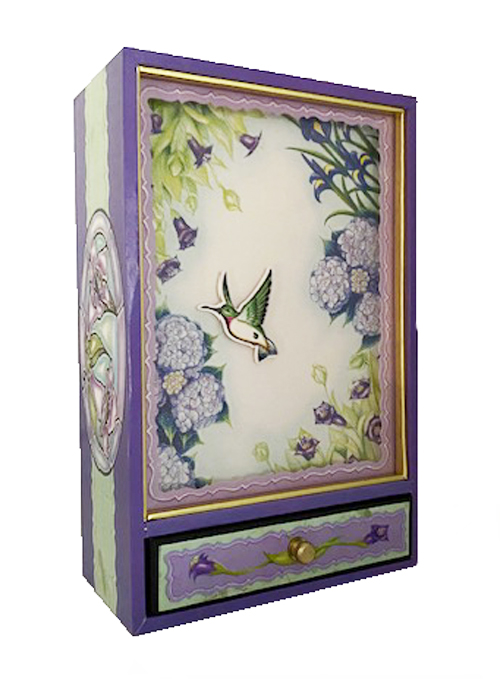 Animated hummingbird flies among flowers in musical shadow box