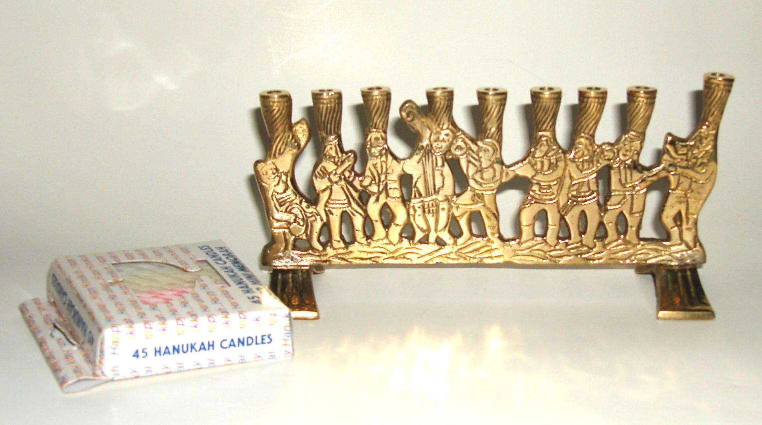 small brass Chanukah menorah with musicians