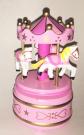 small wooden carousel in pink