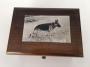 engraved image of Germans Shepherd on silver plaque atop music box
