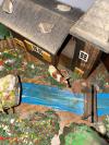 Close Up View of Swiss Village Rivulet with Cow and Bridge